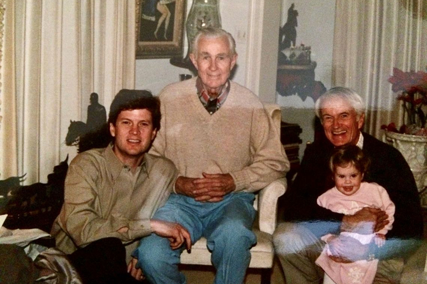 An archival photo of several generations of the Ramser family seated together at home.